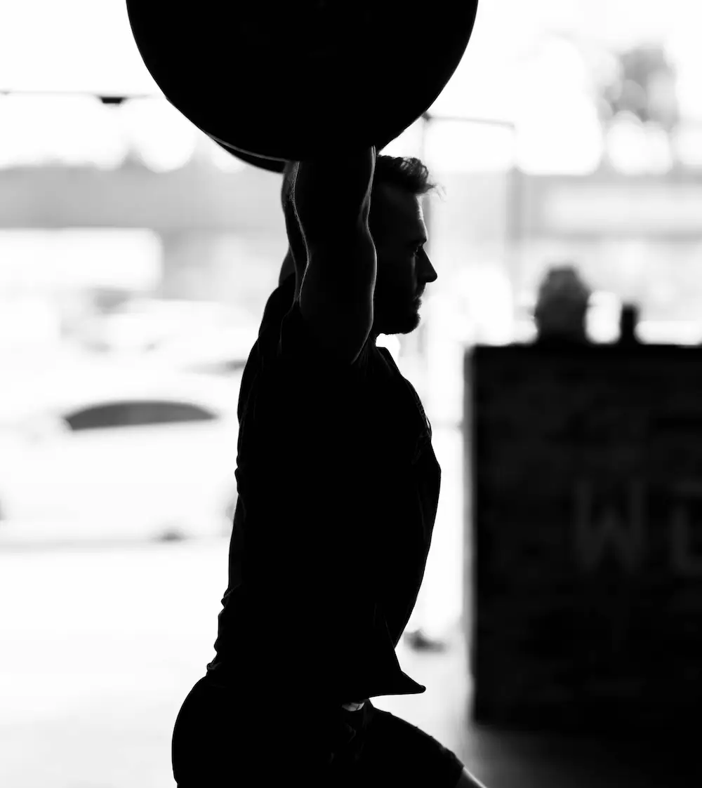 aging crossfit athlete with barbell overhead
